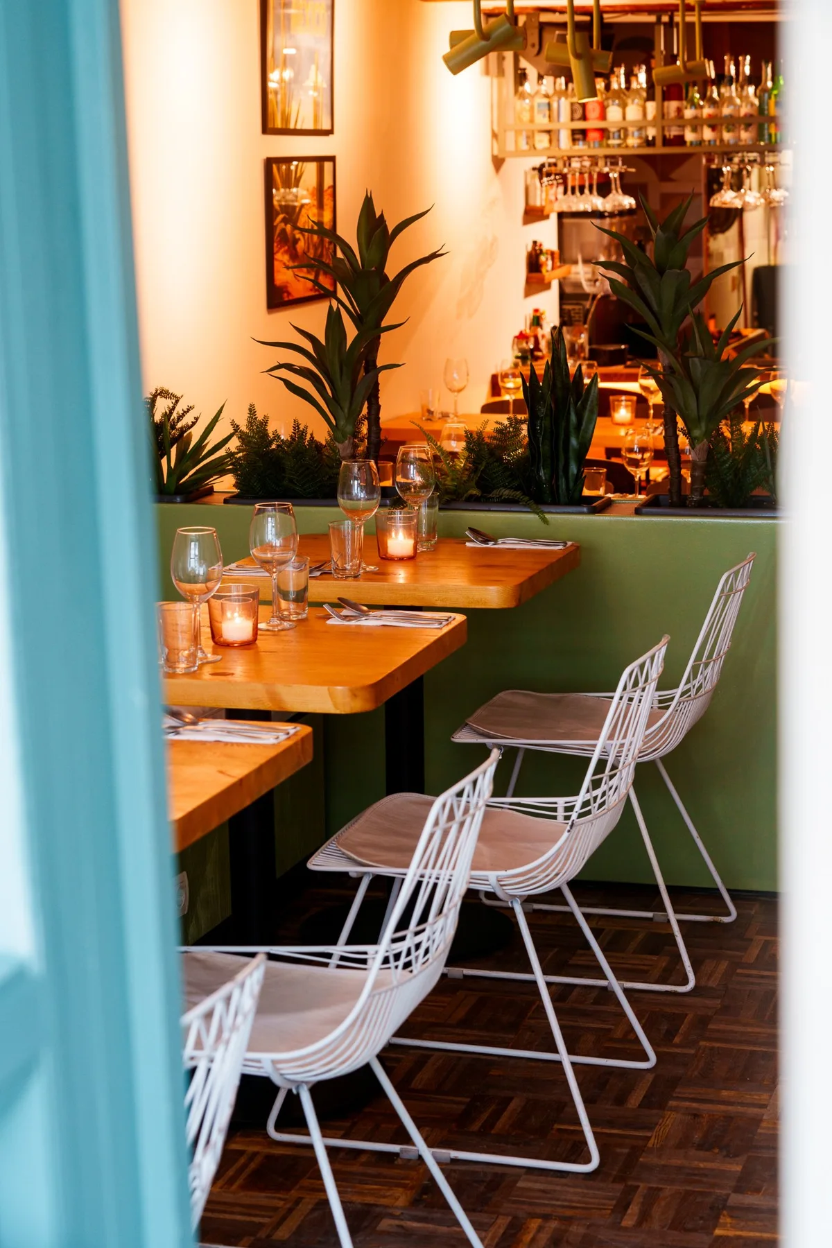 Tables and chairs beside the entrance at Copal